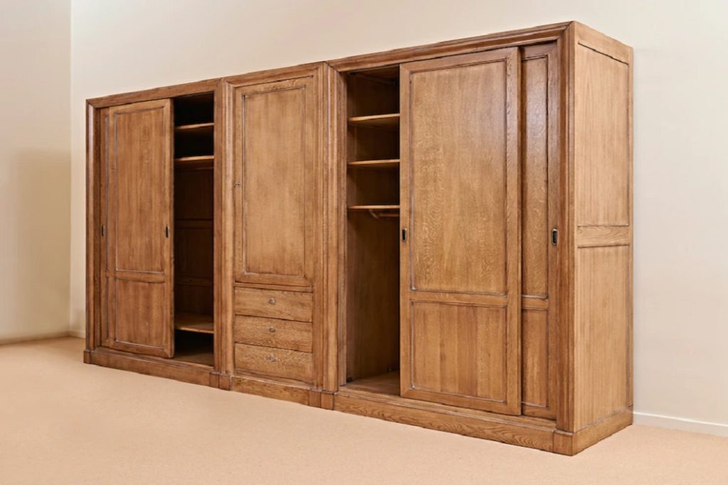 opened-classical-wooden-wardrobe-against-textured-wall_101296-577