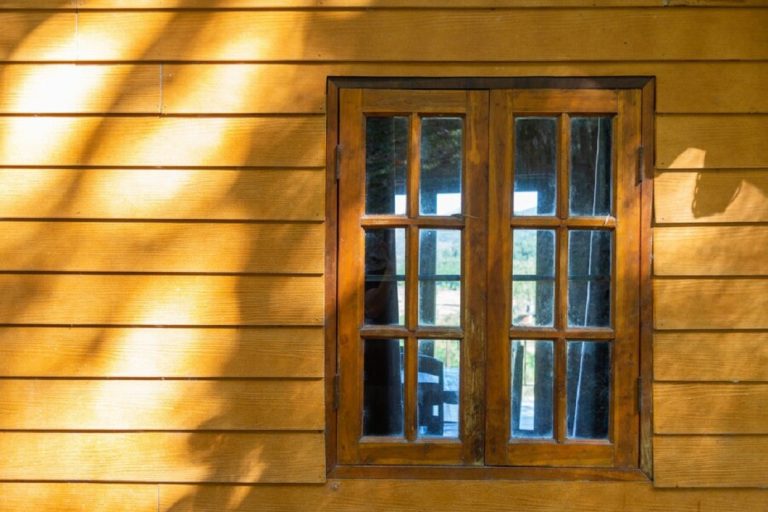 wooden-window-wooden-wall-with-sunshine_35782-102